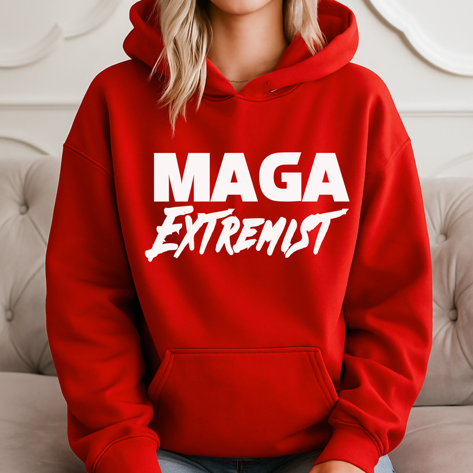 Close-up of red MAGA Extremist hoodie with bold white graphic