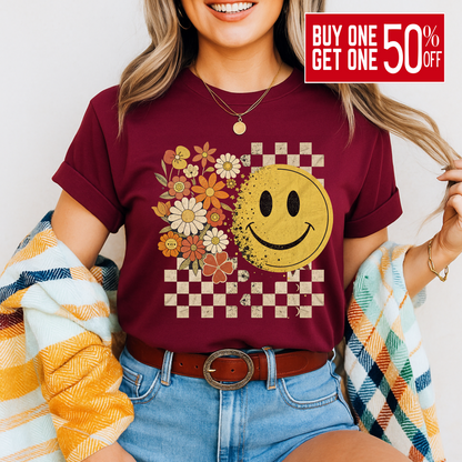 Maroon fall graphic tee with retro smiley face and checkered background

