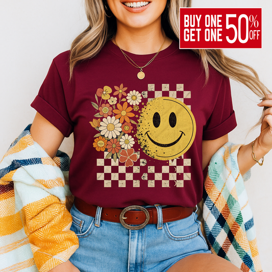 Maroon fall graphic tee with retro smiley face and checkered background

