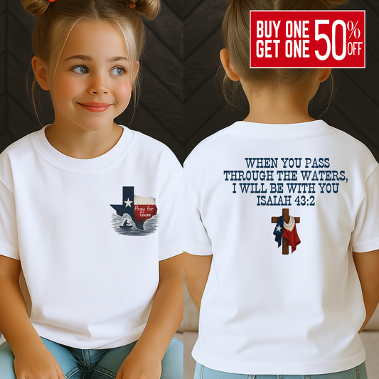 Front and back view of a young girl wearing a white Christian T-shirt featuring a “Pray for Texas” design with a flood scene inside the Texas state outline on the front, and the Bible verse Isaiah 43:2 on the back with a wooden cross and Texas flag. Youth faith-based support shirt for Texas flood relief.