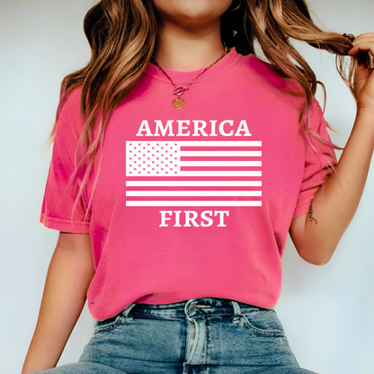 Model wearing hot pink shirt with white “America First” design, posing casually