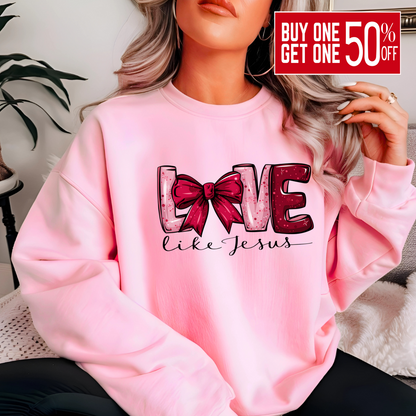 Person wearing a pink sweatshirt with 'LOVE' text and bow design.