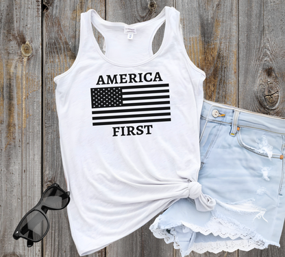 White racerback tank styled with shorts and sunglasses, featuring black America First flag print