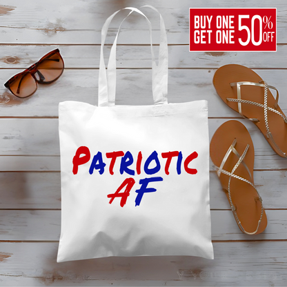 Woman holding canvas tote bag with bold red and blue 'Patriotic AF' text