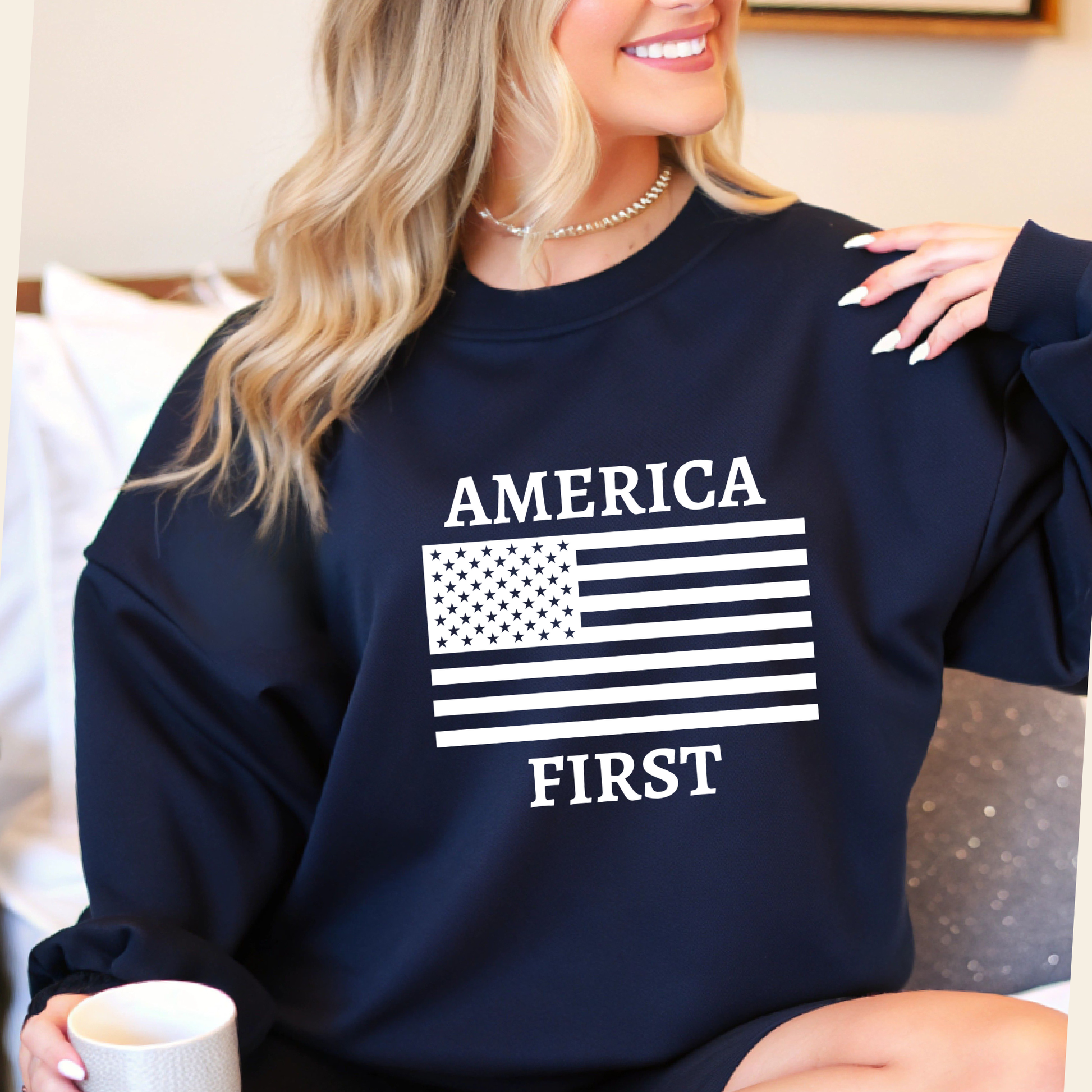 Woman wearing a Navy "America First" sweatshirt while in a social setting. 