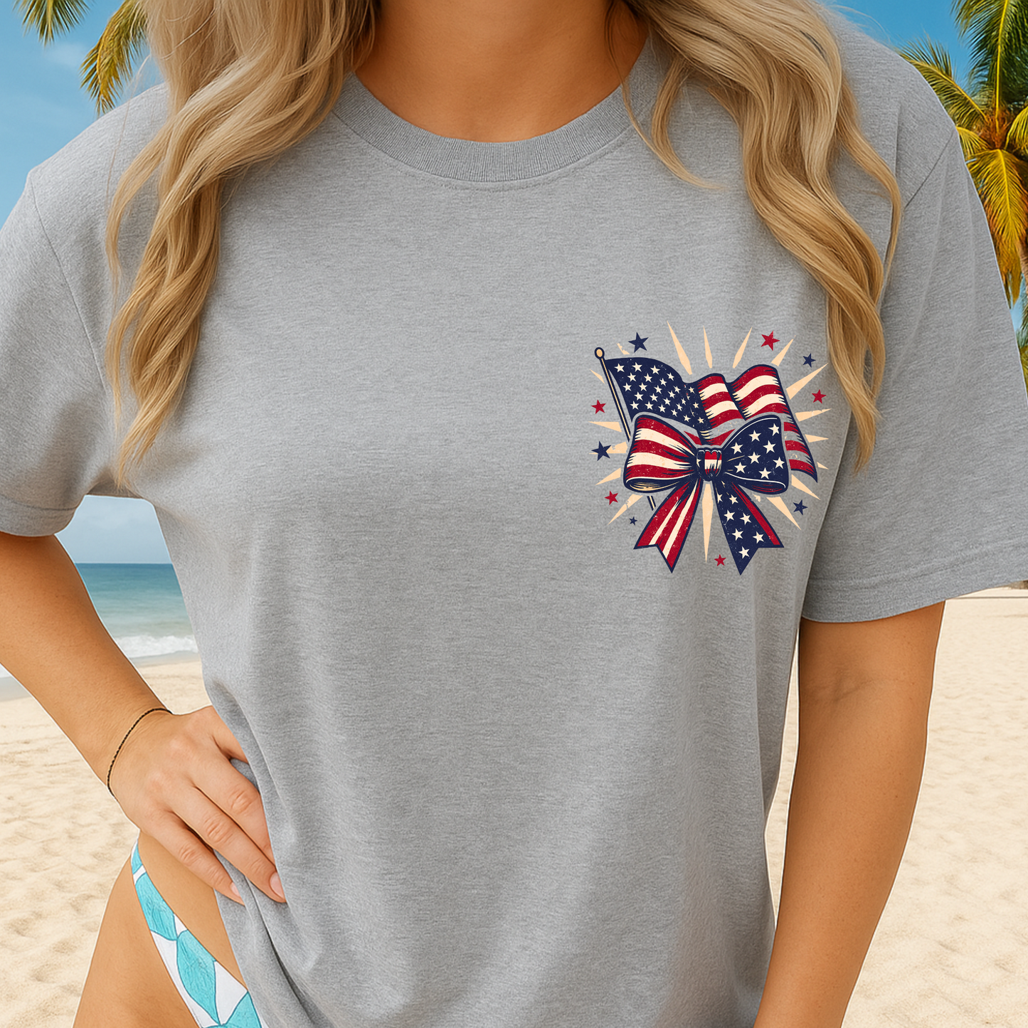 Woman wearing sports gray patriotic bow T-shirt on the beach – front design view