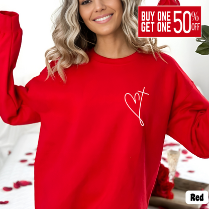 Woman wearing a red sweatshirt with minimalist heart and cross chest design, Valentine's Day outfit