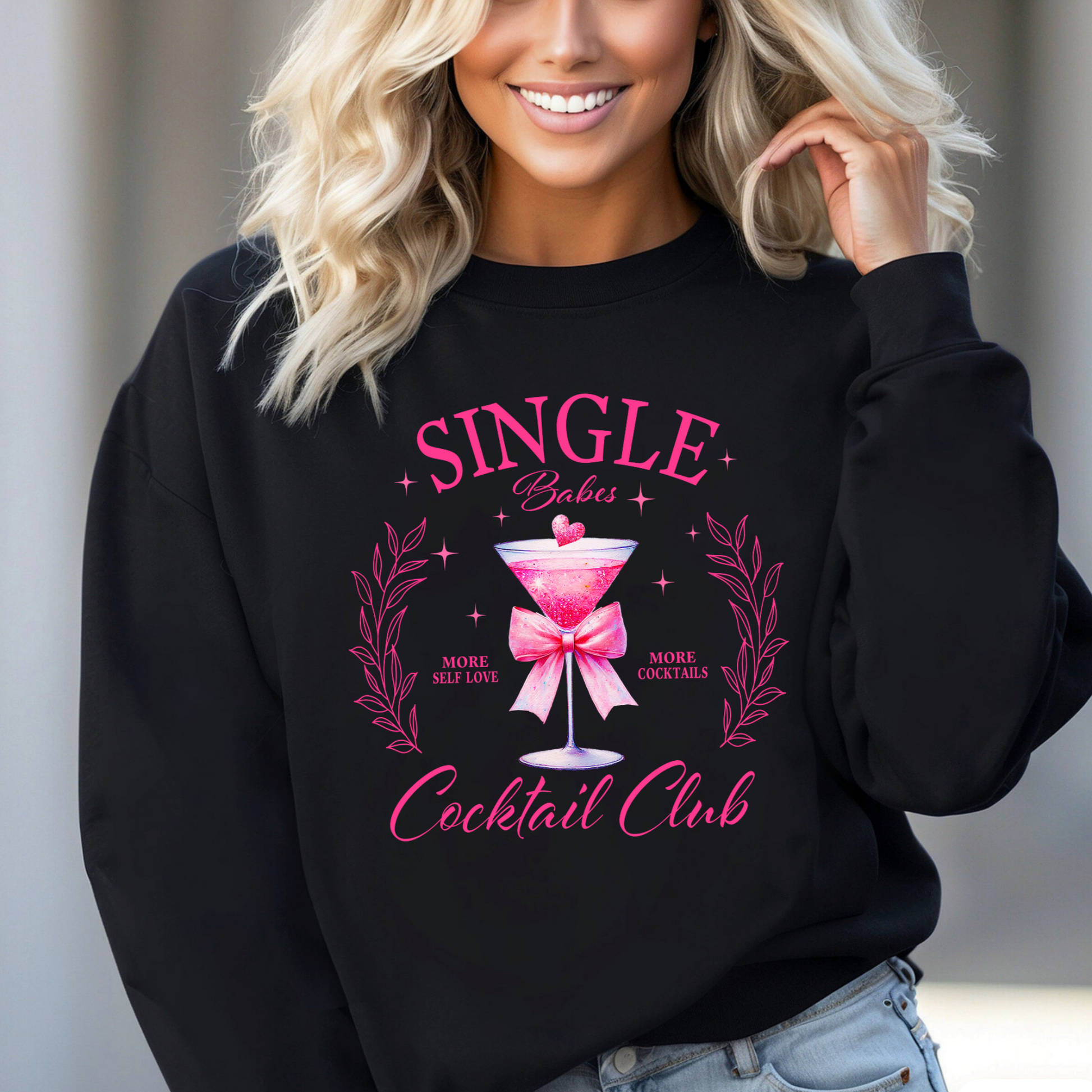 Woman wearing black "Single Babes Cocktail Club" sweatshirt
