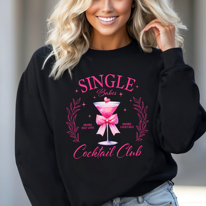 Woman wearing black "Single Babes Cocktail Club" sweatshirt