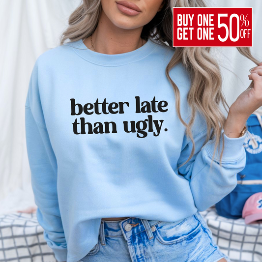 oman wearing light blue “Better Late Than Ugly” sweatshirt styled with distressed denim shorts. Trendy teen and women’s pullover perfect for casual outfits, school, or social media selfies. Unisex fit with cozy comfort and bold attitude.