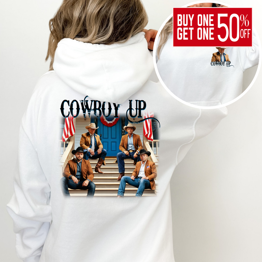 White hoodie with 'Cowboy Up' design featuring four men on steps, surrounded by American flags.